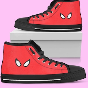May include: Pair of red high-top sneakers with black accents. The sneakers feature a white eye-shaped design on the side and black laces. The soles are black with a white stripe.