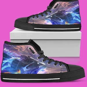 May include: High-top canvas sneakers with a colorful space-themed design. The shoes feature a black rubber sole, black laces, and a vibrant print of a futuristic cityscape with blue and orange hues. The sneakers are displayed on a white box against a pink background.