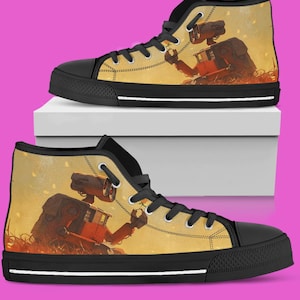 May include: High-top canvas sneakers with a black sole and laces. The sides of the shoes feature a detailed illustration of a robot in a desert landscape, with a warm color palette of orange, yellow, and brown.