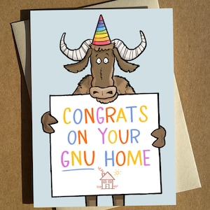 May include: A humorous greeting card featuring a cartoon wildebeest in a rainbow party hat. The wildebeest holds a sign with the text "CONGRATS ON YOUR GNU HOME" in various colours. A small house illustration is at the bottom.