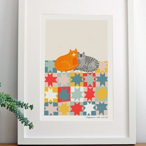 May include: Two cats, one orange and one grey, are cuddling on a colourful patchwork quilt with a star pattern. The quilt is made up of squares of different colours, including red, yellow, blue, green, and pink. The cats are looking at each other and appear to be very close. The image is framed in a white frame.
