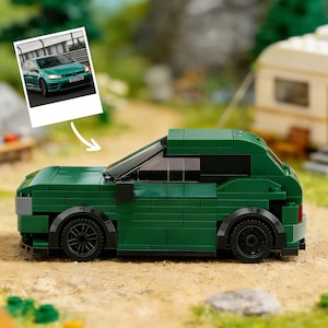 May include: A white ceramic mug with a black handle and the text "But First, Coffee" in a handwritten style. The mug is on a white surface. The mug is approximately 4 inches tall.