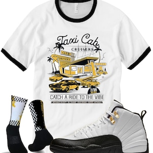 May include: A white t-shirt with black trim featuring a retro taxi cab design, paired with black and white checkered socks and a white and black basketball shoe. The shirt reads "Taxi Cab Cruisers" and "Catch a Ride to the Vibe".