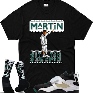 May include: Black t-shirt with a graphic of a man pointing, the word "MARTIN" in white and teal, and the phrase "GET TAH STEPPIN". The image also shows black and white socks, and black, white, and teal sneakers.