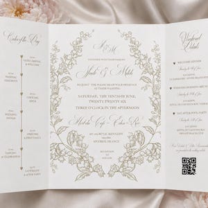 May include: A tri-fold wedding invitation with floral design and elegant script. The invitation includes the names of the couple, wedding details, and a QR code. The color scheme is ivory and gold.