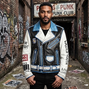 May include: Black, white, and blue leather jacket with silver studs. The jacket has white sleeves with text and patches. The collar and zipper trim are blue. The jacket is worn over a black shirt.
