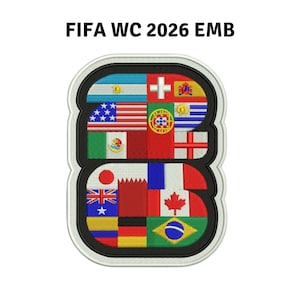 May include: An embroidered patch shaped like the number 2026, featuring various national flags within the digits. The text FIFA WC 2026 EMB appears above the patch, which has a black border and a white outer edge, showcasing detailed stitching.