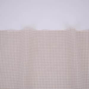 May include: A piece of fabric featuring a small-scale beige and white gingham check pattern. The material is draped to create soft, vertical folds across the surface, displaying a consistent grid design throughout the visible textile area.
