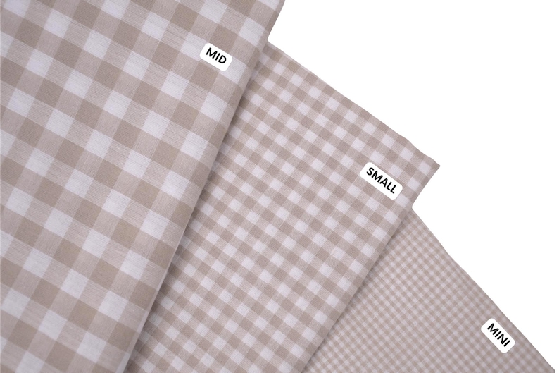 May include: Three pieces of fabric featuring a beige and white gingham check pattern. Each piece is labeled with a white tag containing black text: MID for the largest check, SMALL for the medium check, and MINI for the smallest check pattern.