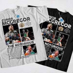 May include: Two t-shirts, one white and one black, featuring a design dedicated to Conor McGregor. The design includes images of McGregor, the text "CONOR MCGREGOR" and "THE NOTORIOUS", and text in Spanish.