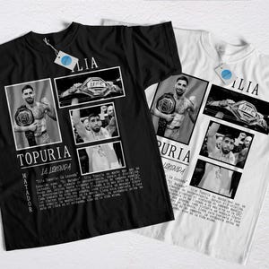 Könnte beinhalten: Schwarze und weiße T-Shirts mit einer Collage von Bildern eines Mannes mit einem Meisterschaftsgürtel. Die Shirts tragen den Namen "TOPURIA" und den Text "LA LEYENDA".
