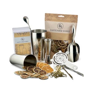 May include: A stainless steel cocktail shaker set with various bar tools, including a jigger, strainer, muddler, and spoon. The set includes a bag of dried orange slices and a box labeled "Bartender Supply."