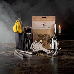 May include: A bartender supply kit featuring a black cocktail shaker, a yellow citrus press, a silver jigger, a Hawthorne strainer, a metal ice scoop, two pour spouts, metal tongs, and a bag of dried citrus slices labeled Bartender Supply.