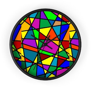 May include: A round wall clock with a black frame and a face featuring a vibrant, multi-colored geometric pattern of triangles and polygons in shades of red, blue, green, yellow, orange, and purple, separated by thick black lines.