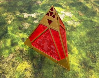 May include: A geometric, pyramid-shaped object with a red, textured center and gold-colored edges. The top section features triangular cutouts. The object is set against a backdrop of green and brown terrain.