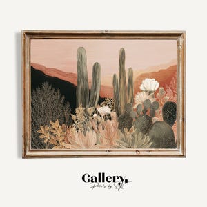 May include: A framed print depicting a desert scene with cacti, flowers, and mountains under a sunset. The artwork uses muted peach, green, and brown tones. The text "Gallery. Prints by SK" is in the bottom right corner.