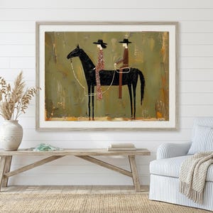 May include: Framed artwork featuring a black horse with two riders in hats. The riders are dressed in patterned and solid clothing. The background is a textured olive green with a light brown frame. The artwork is displayed above a wooden bench.