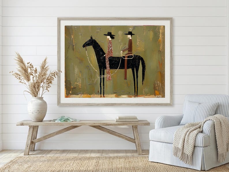 May include: Framed artwork featuring a black horse with two riders in hats. The riders are dressed in patterned and solid clothing. The background is a textured olive green with a light brown frame. The artwork is displayed above a wooden bench.