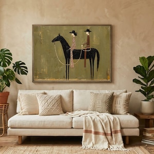 May include: A framed rectangular wall art piece featuring a stylized painting of two figures riding a black horse against a textured olive green background. The figures wear wide-brimmed hats, with one in a patterned dress and the other in a brown outfit.