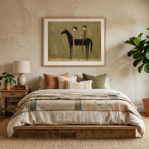 May include: A bedroom scene featuring a bed with a patterned quilt, pillows, and a wooden frame. A framed artwork depicting a horse and rider hangs above the bed. A potted plant and a lamp are on a wooden nightstand. The room has a neutral color palette.
