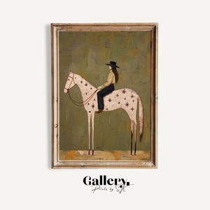 May include: A framed wall art print featuring a painting of a person in a black hat, tan shirt, and dark pants riding a white horse with a star pattern. The horse has a red bridle and stands against a textured olive green background.
