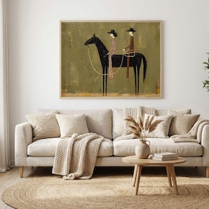 May include: A rectangular wall art print featuring a stylized black horse with two riders wearing hats. The riders are dressed in brown and patterned clothing. The background is a textured olive green with a light brown base, framed in light wood.