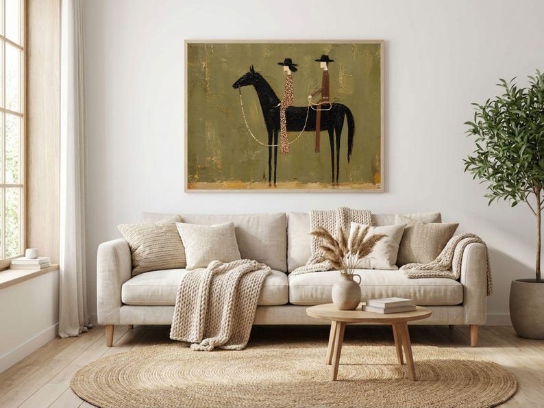 May include: A rectangular wall art print featuring a stylized black horse with two riders wearing hats. The riders are dressed in brown and patterned clothing. The background is a textured olive green with a light brown base, framed in light wood.