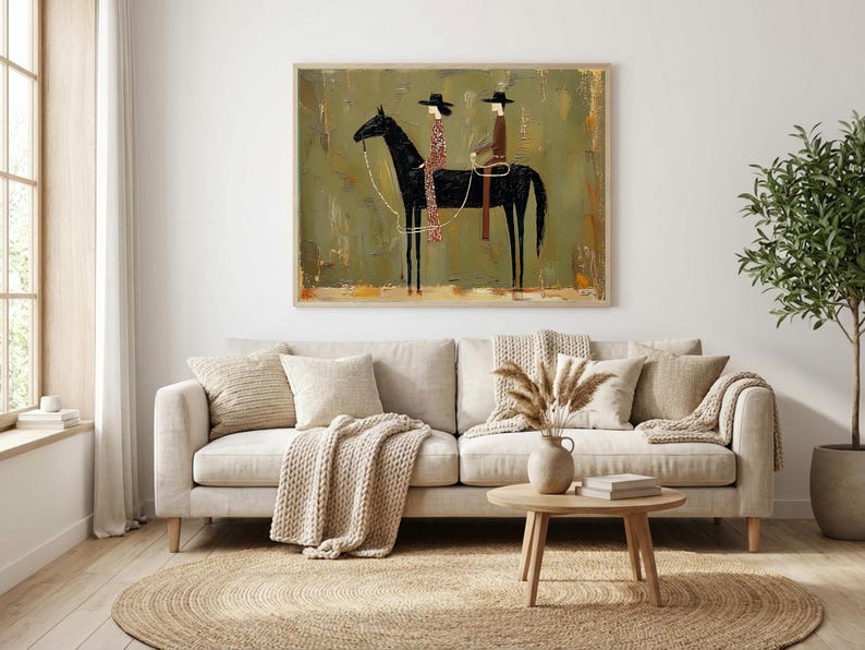 May include: An abstract painting depicts two figures on horseback. The black horse is the focal point, with riders in hats and patterned clothing. The background has a textured, olive-green appearance, and the artwork is framed in a light-colored wooden frame.