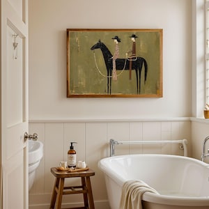 May include: A rectangular framed wall art piece featuring a stylized painting of a black horse with two riders in hats. The background is a muted olive green. The riders are depicted in a simplified, linear fashion, one wearing a patterned garment.