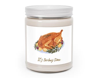 May include: A candle in a jar with a white lid. The label features a watercolor illustration of a roasted turkey on a platter with lemons and herbs. The text "It's turkey time" is below the image.