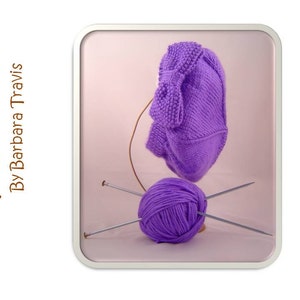 May include: Purple knitted hat with a bow on top, a ball of purple yarn, and two knitting needles on a pink background. The text "Pattern By Barbara Travis" is on the left side of the image.