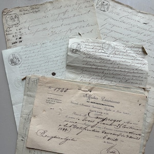 May include: A collection of aged, handwritten documents with faded ink and various seals. The papers are layered, showing different sizes and textures, with visible text and signatures. The overall aesthetic is vintage and historical.