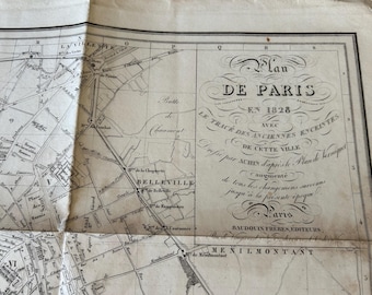 May include: A vintage map of Paris, France, from 1828. The map shows the city's layout with streets, buildings, and landmarks. The title "Plan de Paris" is written in a decorative script.