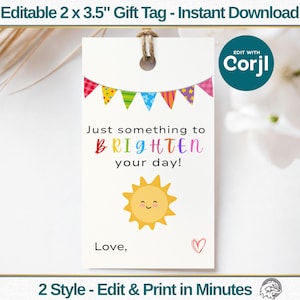 May include: A white gift tag, 2 x 3.5 inches, with a colorful banner across the top. The tag features the text "Just something to BRIGHTEN your day!" and a smiling sun illustration. Includes the text "Love," and a heart.