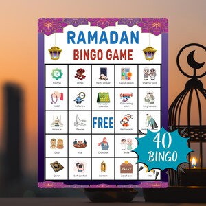 May include: A Ramadan Bingo Game card with a purple and gold border. The card features a grid with various Ramadan-themed images and words, including "Fasting," "Dates," and "Quran." The words "Ramadan Bingo Game" are at the top, and "40 Bingo" is at the bottom.