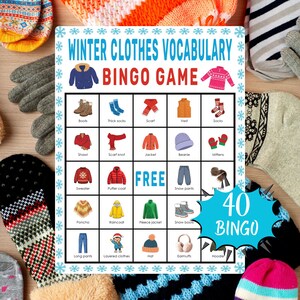 May include: A winter clothes vocabulary bingo game card with illustrations of winter clothing items like boots, jackets, and hats. The card has the text "Winter Clothes Vocabulary Bingo Game" and "FREE" in the center. The card is surrounded by snowflakes.