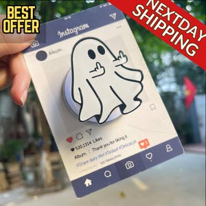 May include: A white ghost-shaped phone grip with a black outline, giving the middle finger. The grip is attached to a mock Instagram post with the text "BEST OFFER" and "NEXTDAY SHIPPING". The post has the text "520.1314 Likes" and "Thank you for liking it".