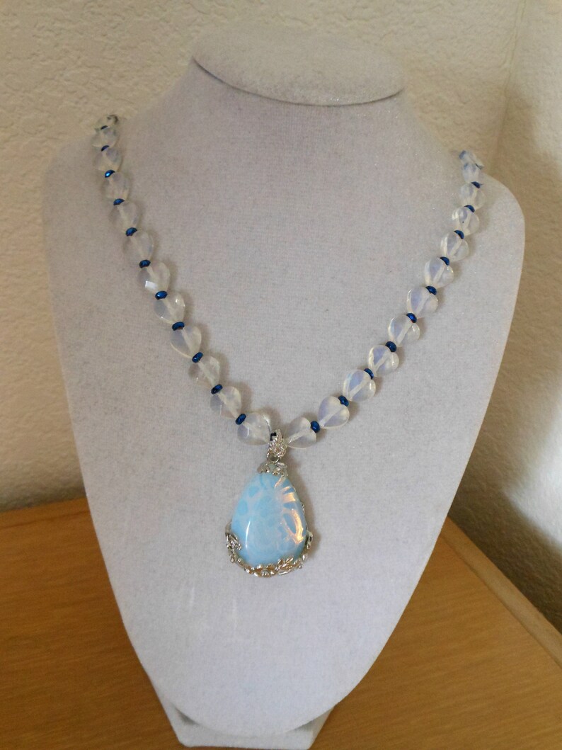 Opalite and heart DelightGenuine opalite pendant with floral design bale with opalite faceted heart beads and blue crystal spacerswomens n