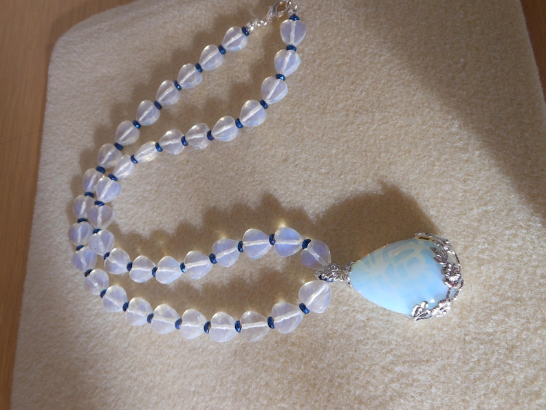 Opalite and heart DelightGenuine opalite pendant with floral design bale with opalite faceted heart beads and blue crystal spacerswomens n