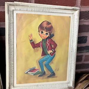 May include: Framed vintage print of a wide-eyed child in a red jacket, green sweater, and blue pants. The child is standing near books labeled "HISTORY" and "ARITHMETIC". The artwork is signed "EVE" and is set in a white distressed frame.