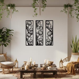 May include: Three black metal wall art panels, each featuring a floral iris design. The panels are rectangular and arranged vertically, creating a cohesive decorative display. The iris flowers are intricately cut out, showcasing the details of the petals and stems.
