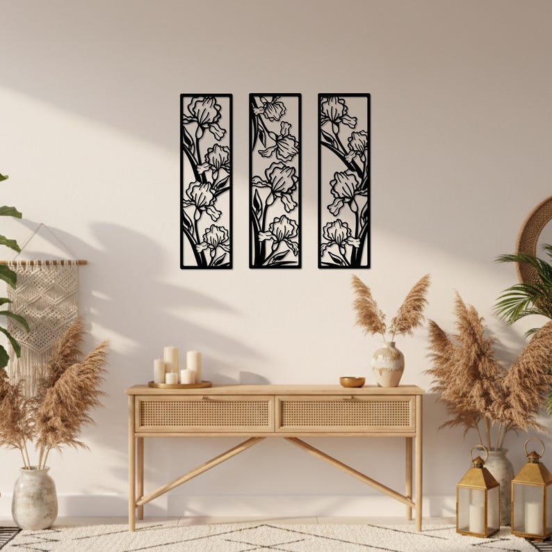 May include: Three black metal wall art panels, each featuring a floral iris design. The panels are rectangular and arranged vertically, creating a cohesive decorative display. The iris flowers are intricately cut out, showcasing the details of the petals and stems.