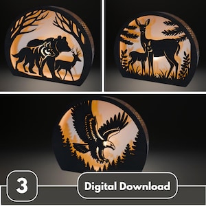 May include: Three illuminated wooden silhouette lamps featuring wildlife scenes. One shows a bear, wolf, and deer; another, a doe and fawn; and the last, an eagle. The lamps have a warm, inviting glow and the text "Digital Download".
