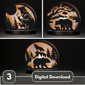 May include: Three illuminated, laser-cut wooden night lights with wildlife scenes. Each features a black silhouette of animals and trees against an orange glow. The text "Digital Download" is visible.