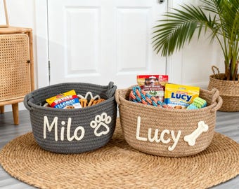 May include: Two rope baskets, one gray and one tan, filled with dog treats and toys. The gray basket is labeled "Milo" with a paw print, and the tan basket is labeled "Lucy" with a bone. Both baskets have handles.