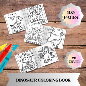 May include: A dinosaur coloring book with several open pages featuring black and white illustrations of dinosaurs in various scenes. The book has 105 pages and 26 covers. Crayons are visible in the lower left corner. The text "DINOSAUR COLORING BOOK" is at the bottom.