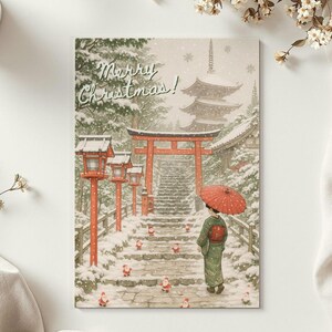 以下が含まれることがあります： 雪の降る日本の風景を描いたクリスマスカード。着物を着た女性が赤い傘を持っています。「Merry Christmas！」の文字と、五重塔、赤い鳥居、灯籠が描かれています。