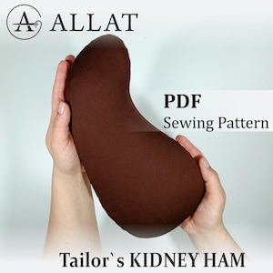 May include: A brown, kidney-shaped sewing pattern held in hands. The text "PDF Sewing Pattern" is displayed on the right side. The logo "ALLAT" is in the upper left corner, and the text "Tailor's KIDNEY HAM" is at the bottom.