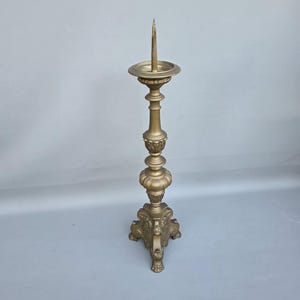 Large brass candlestick in Baroque style with tripod foot ++