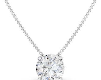 May include: A silver-toned necklace featuring a single round, brilliant-cut clear gemstone set in a four-prong metal setting. The pendant is suspended from a delicate, thin silver-toned chain with small, uniform circular links.